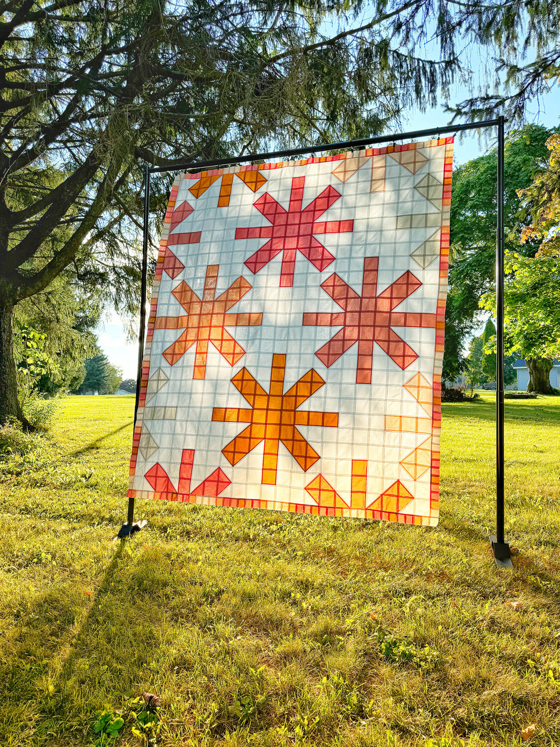 Modern asterisk quilt of solid colored fabrics; a pleasing palette of pinks, tans & golds.