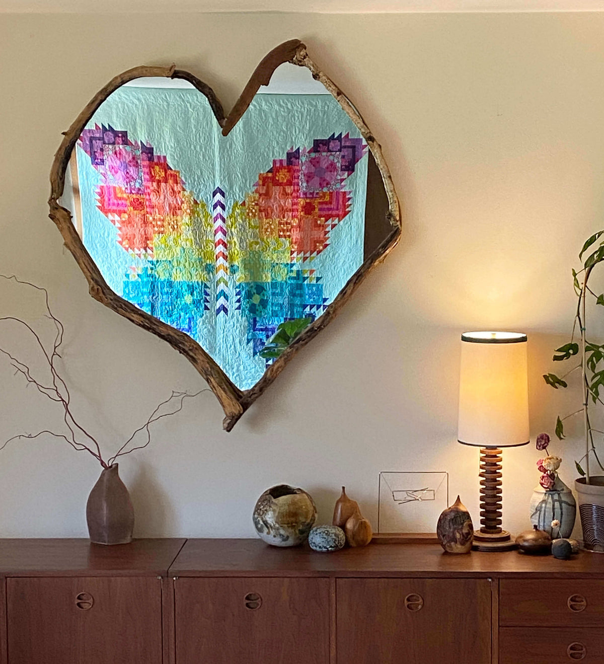 Modern quilt of a patchwork butterfly completed with fabrics arranged in a rainbow colorwash.